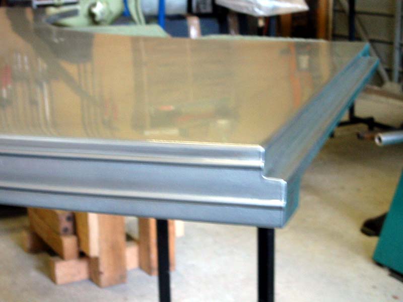 A stainless steel table is sitting in a garage