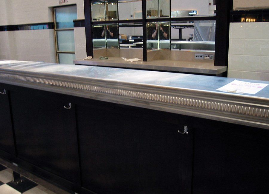 A long counter in a kitchen with black cabinets