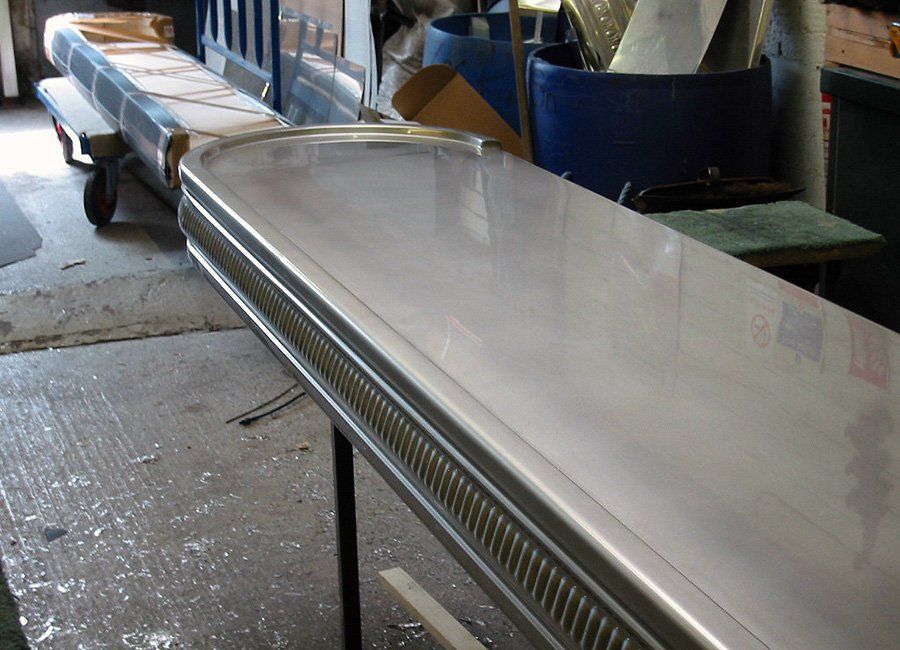 A long stainless steel table is sitting in a room