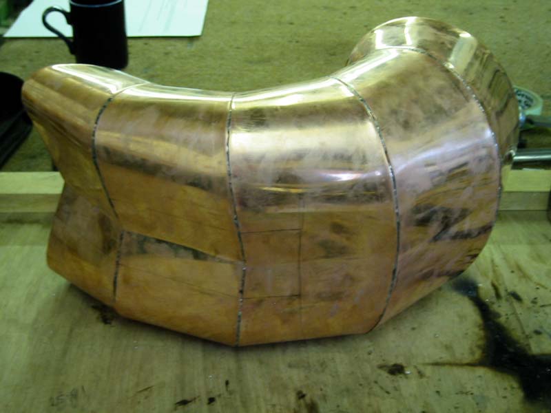 A piece of copper is sitting on a wooden table
