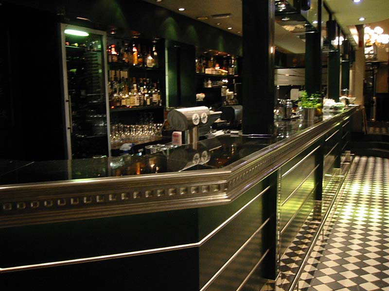 A long bar in a restaurant with a checkered floor