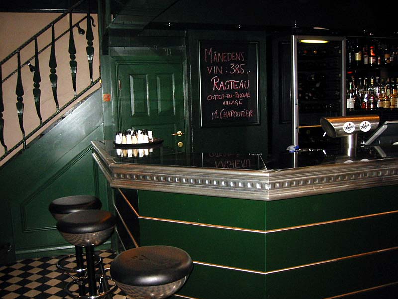 A bar with a sign on the wall that says 