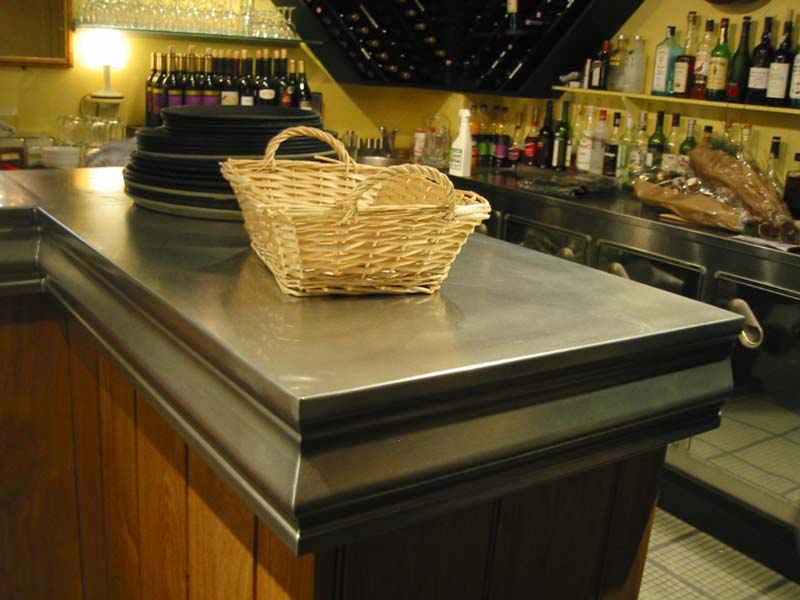 A wicker basket sits on a stainless steel counter in a restaurant