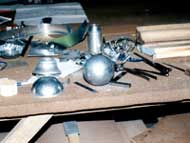 A wooden table with a bunch of metal objects on it.