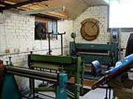 A room with a lot of machinery in it and a clock on the wall.