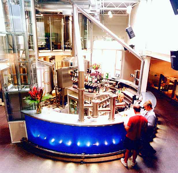 People standing around a blue bar in a restaurant