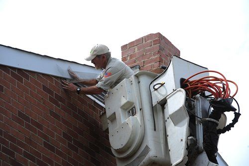 Bat Exclusion Services — Worker Inspecting a Roof in Glenolden, PA