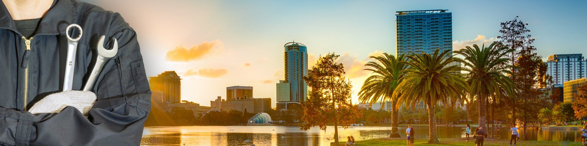 Mechanic holding wrenches, Orlando cityscape in the background. Sunset over water.