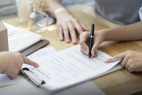 Woman Signing a Contract — Elizabethton, TN — Southern Finance Woman Signing a Contract — Elizabethton, TN — Southern Finance