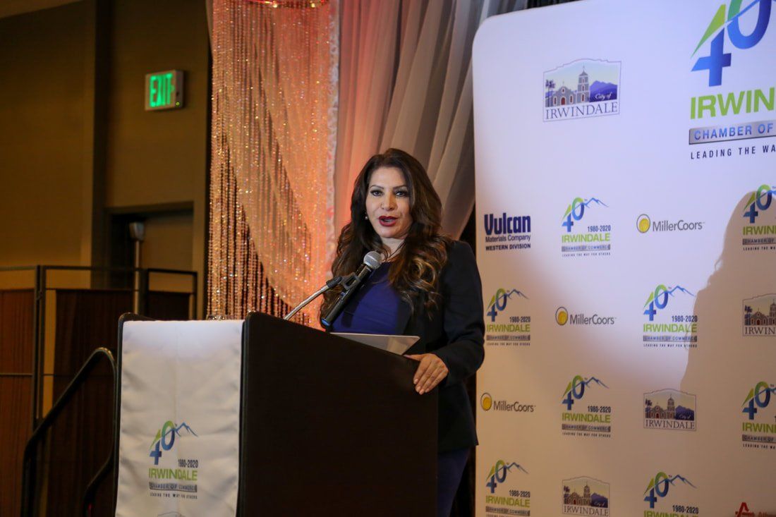 A woman is standing at a podium giving a speech.