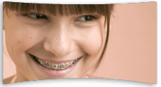 Young girl wearing braces, smiling