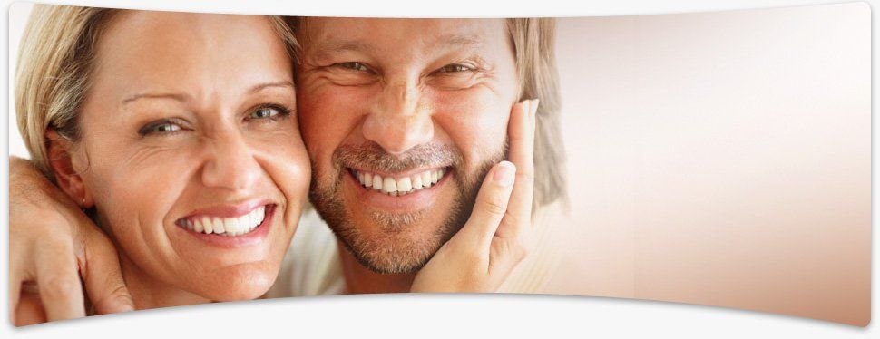 Middle aged couple hugging and smiling for the camera