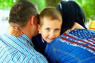 Adoption — Boy Hugging His Mom and Dad in Columbus, GA Adoption — Boy Hugging His Mom and Dad in Columbus, GA