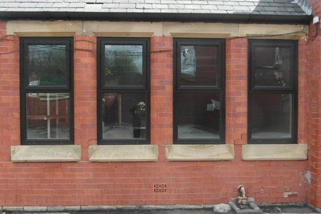 A brick building with a lot of windows on it
