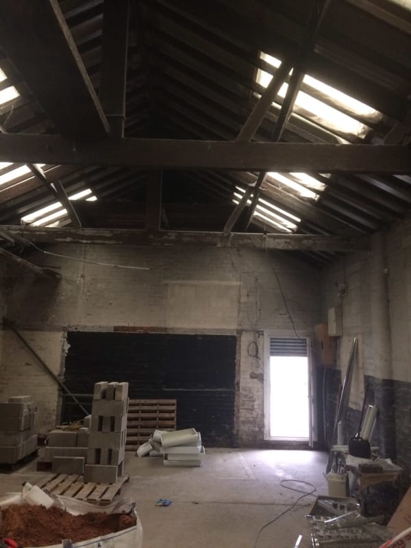 The inside of a building with a roof that has a lot of windows.