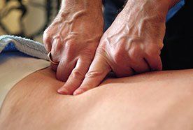 A therapist working on a patient's back