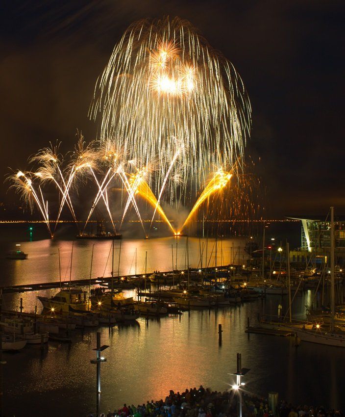 A fireworks display over a body of water