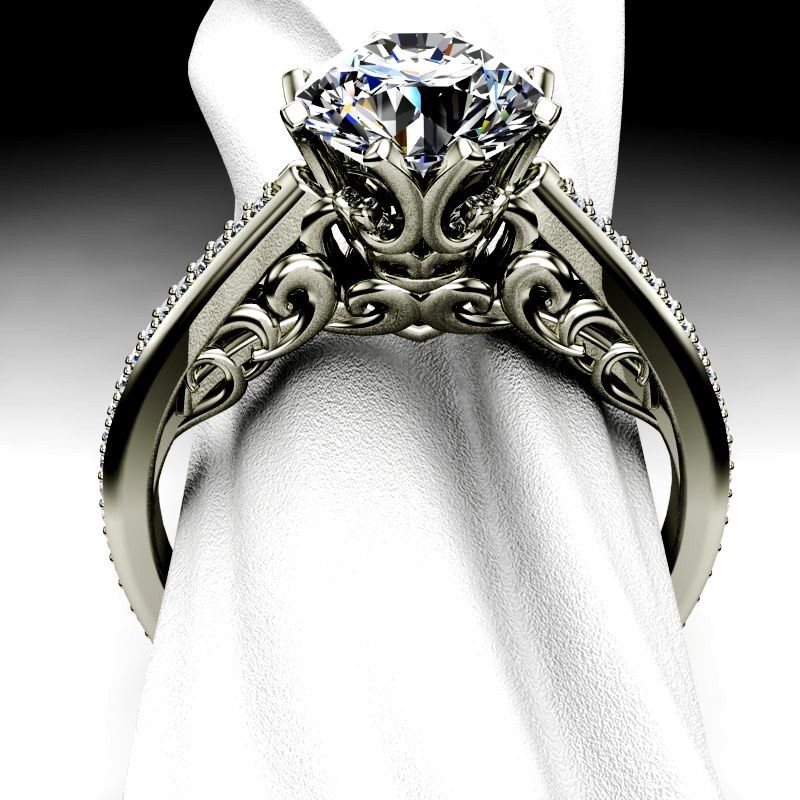 A diamond ring is sitting on a white cloth