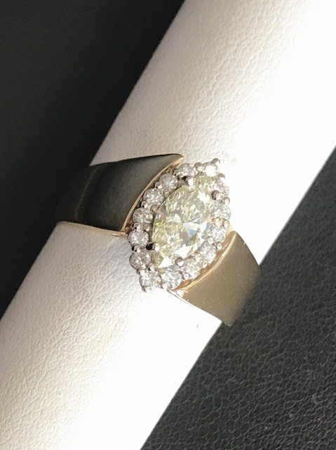 A gold ring with a large diamond in the center