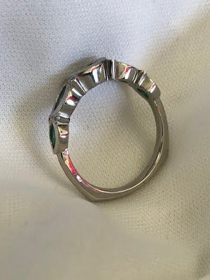 A close up of a ring on a white surface.