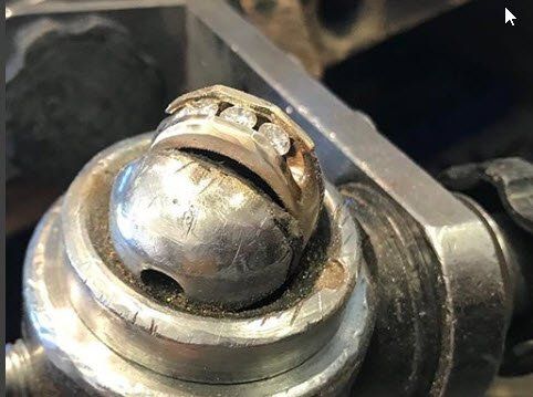 A close up of a metal ball bearing on a metal object.