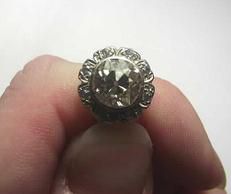 A close up of a person holding a ring on their finger.