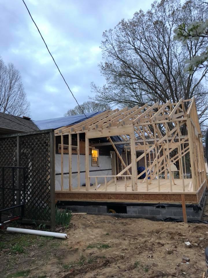 A house is being built in the backyard of a house.
