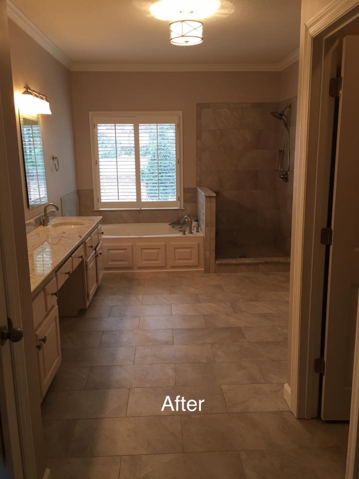 A bathroom with two sinks , a tub , and a shower.