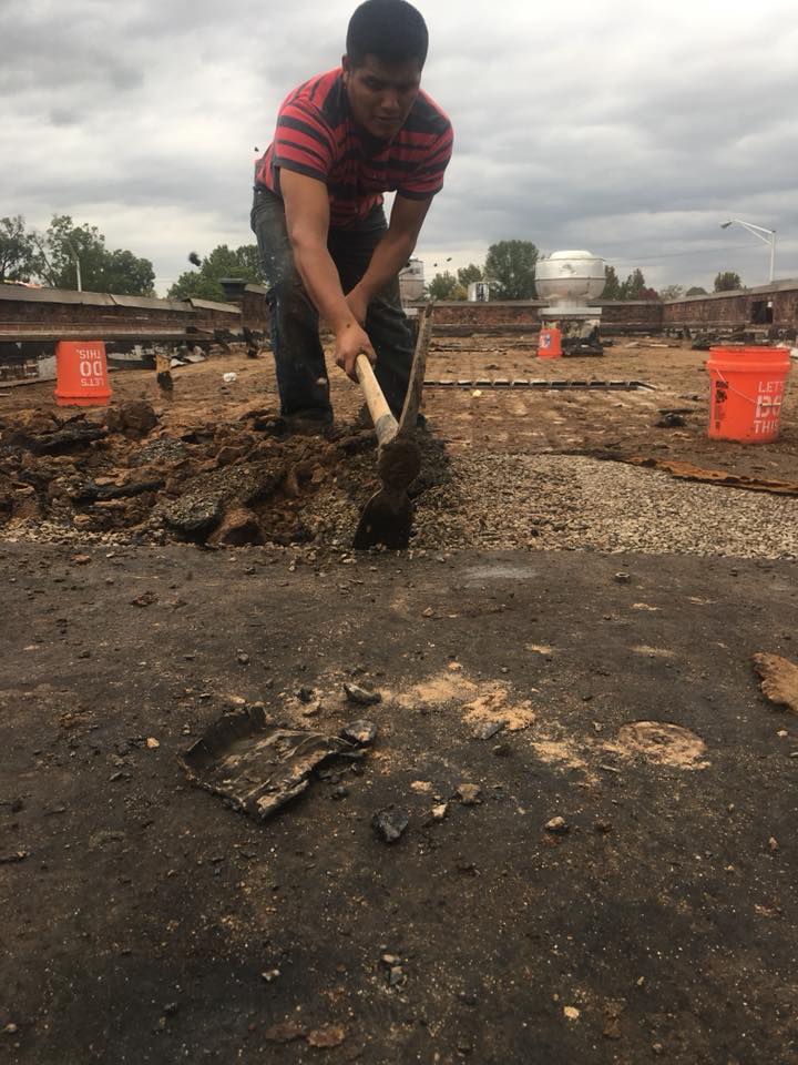 A man is using a shovel to dig a hole in the ground