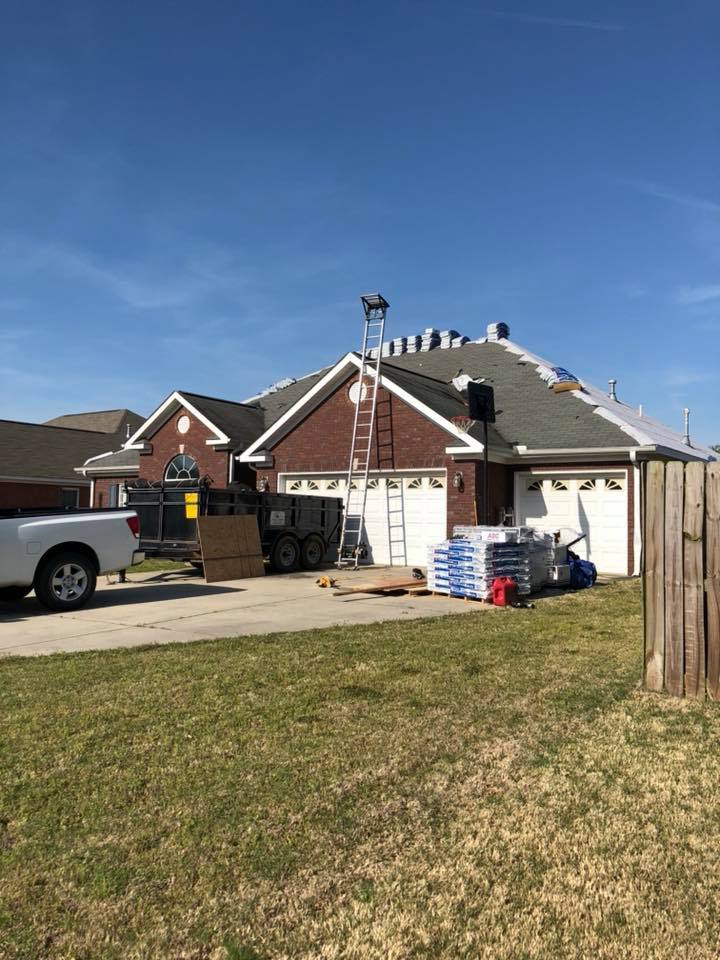 A truck is parked in front of a house that is being remodeled.