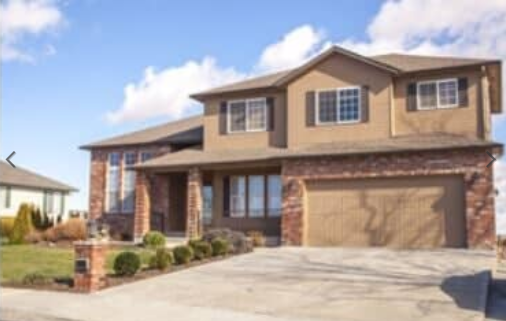 A large house with a garage and a lot of windows