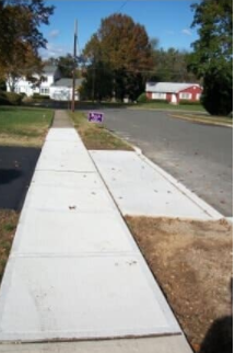A sidewalk with a sign that says no parking