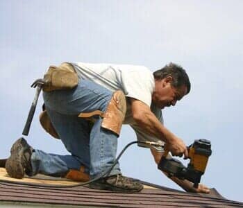 Man putting shingles on roof - tri state in West Congers, NY Man putting shingles on roof - tri state in West Congers, NY