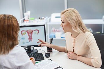 Blonde Girl Consulting With Gynecologist — Medical Health Care in Roseburg, OR