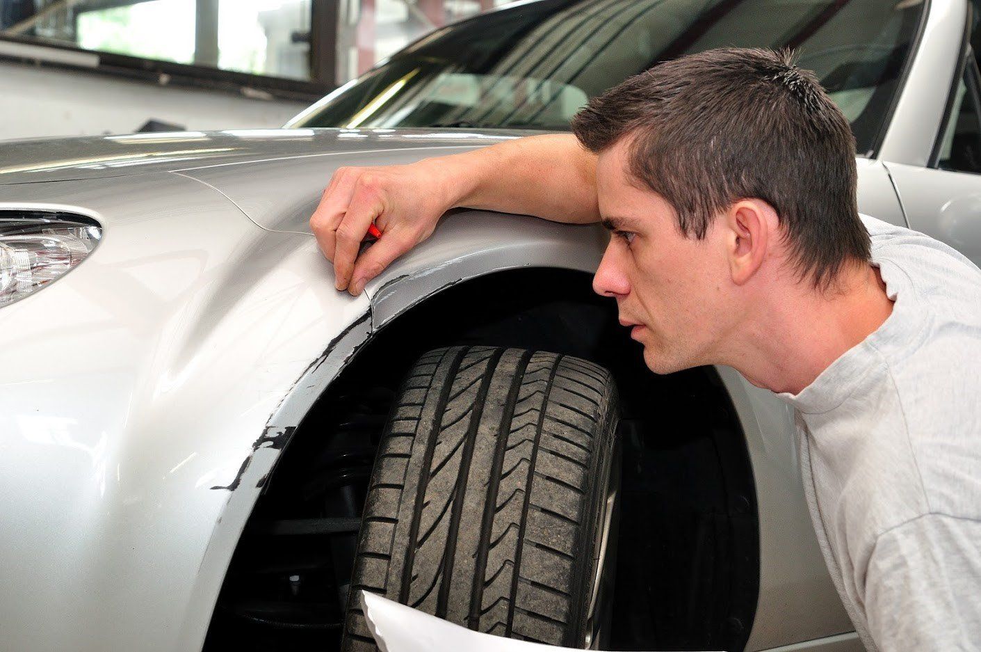  Inspecting Car Damage — Traverse City, MI — Olson’s Auto Body