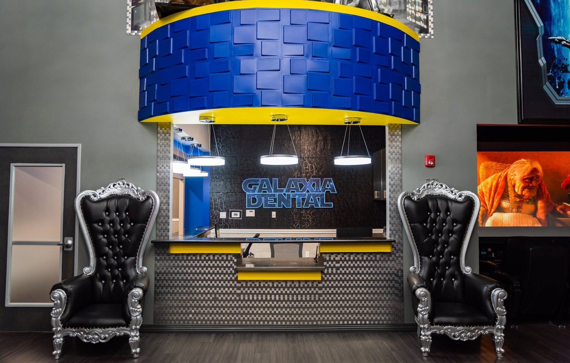 Two chairs in front of a sign that says galactic dental