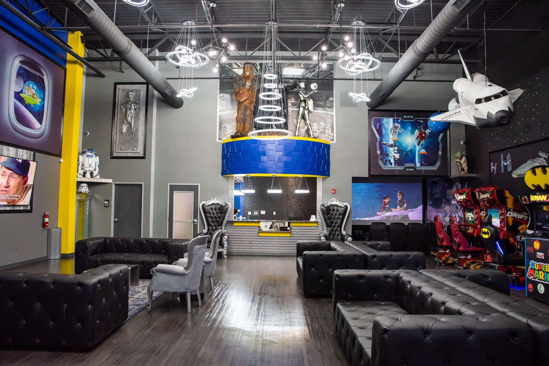 A large room with a lot of furniture and a rocket hanging from the ceiling.