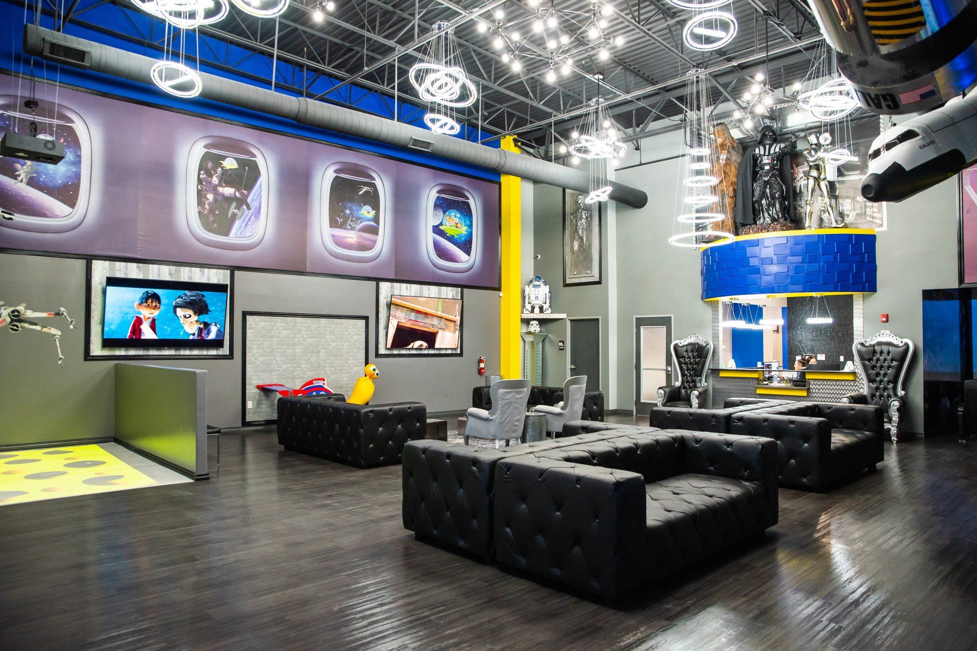 A large room with a lot of furniture and a large airplane on the wall.