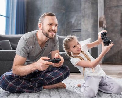 Father and Daughter Playing with Joysticks — Bucks County, PA — Ranniello Inc. Father and Daughter Playing with Joysticks — Bucks County, PA — Ranniello Inc.