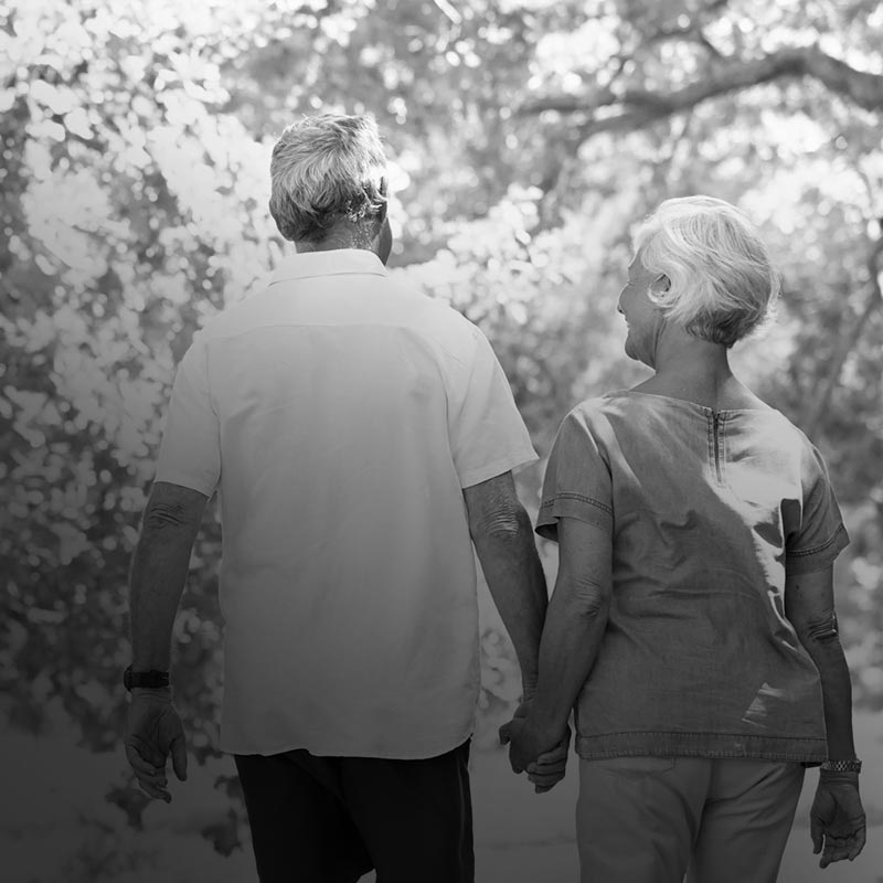 A couple on a walk holding hands.
