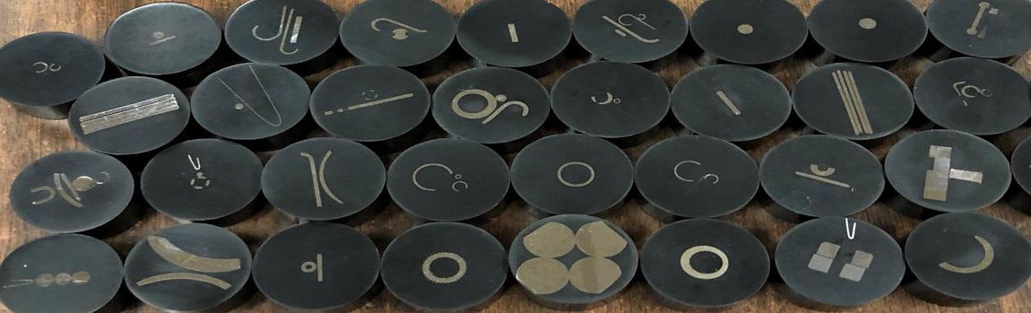 Steel Processing — Black Round Metals with Symbols in Salt Lake City, UT Steel Processing — Black Round Metals with Symbols in Salt Lake City, UT