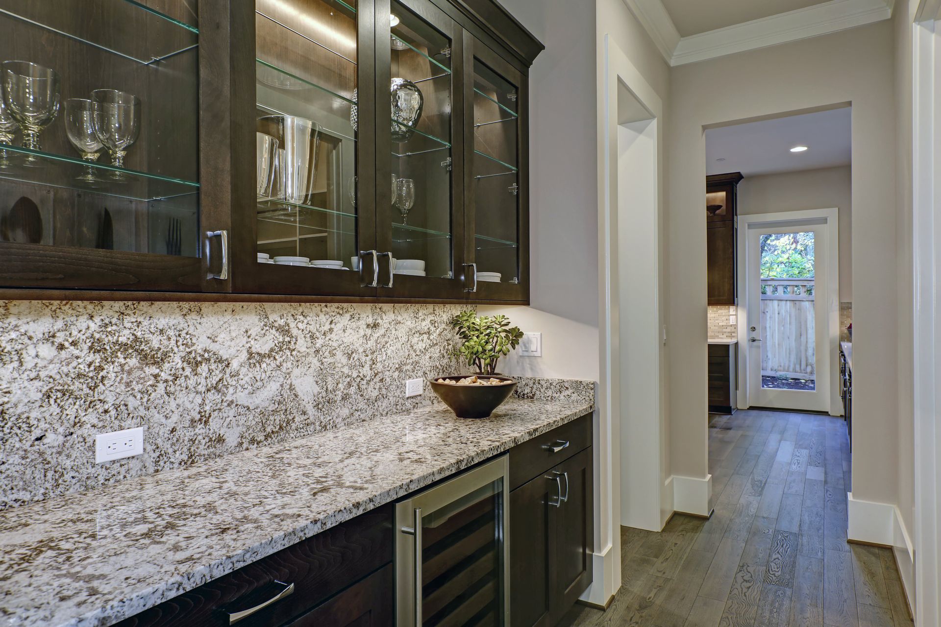 A kitchen with granite counter tops and stainless steel appliances