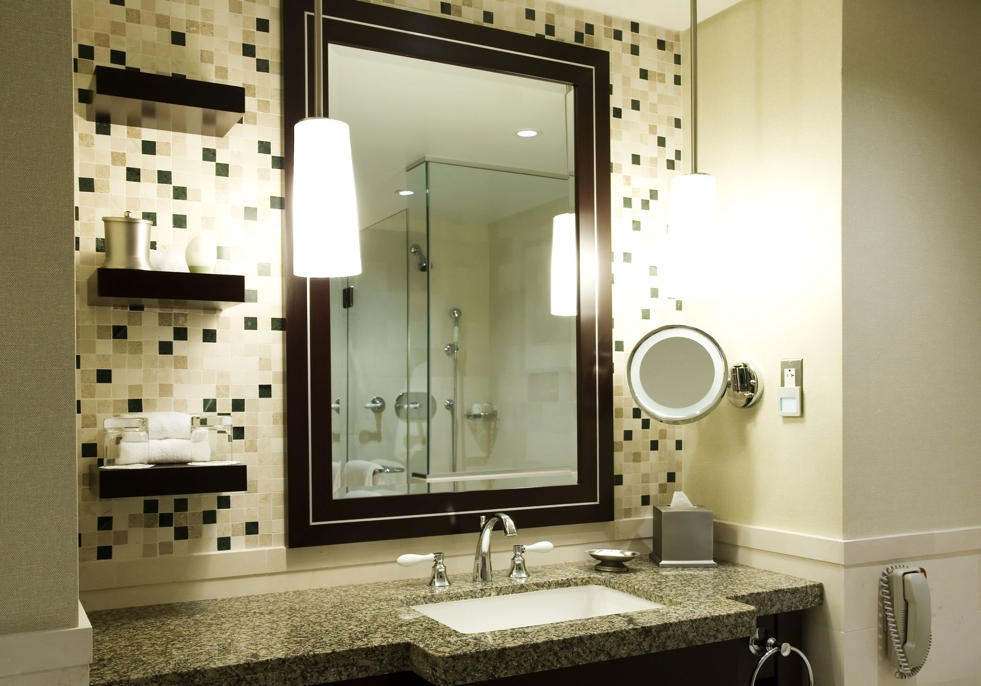 A bathroom with a large mirror and a sink