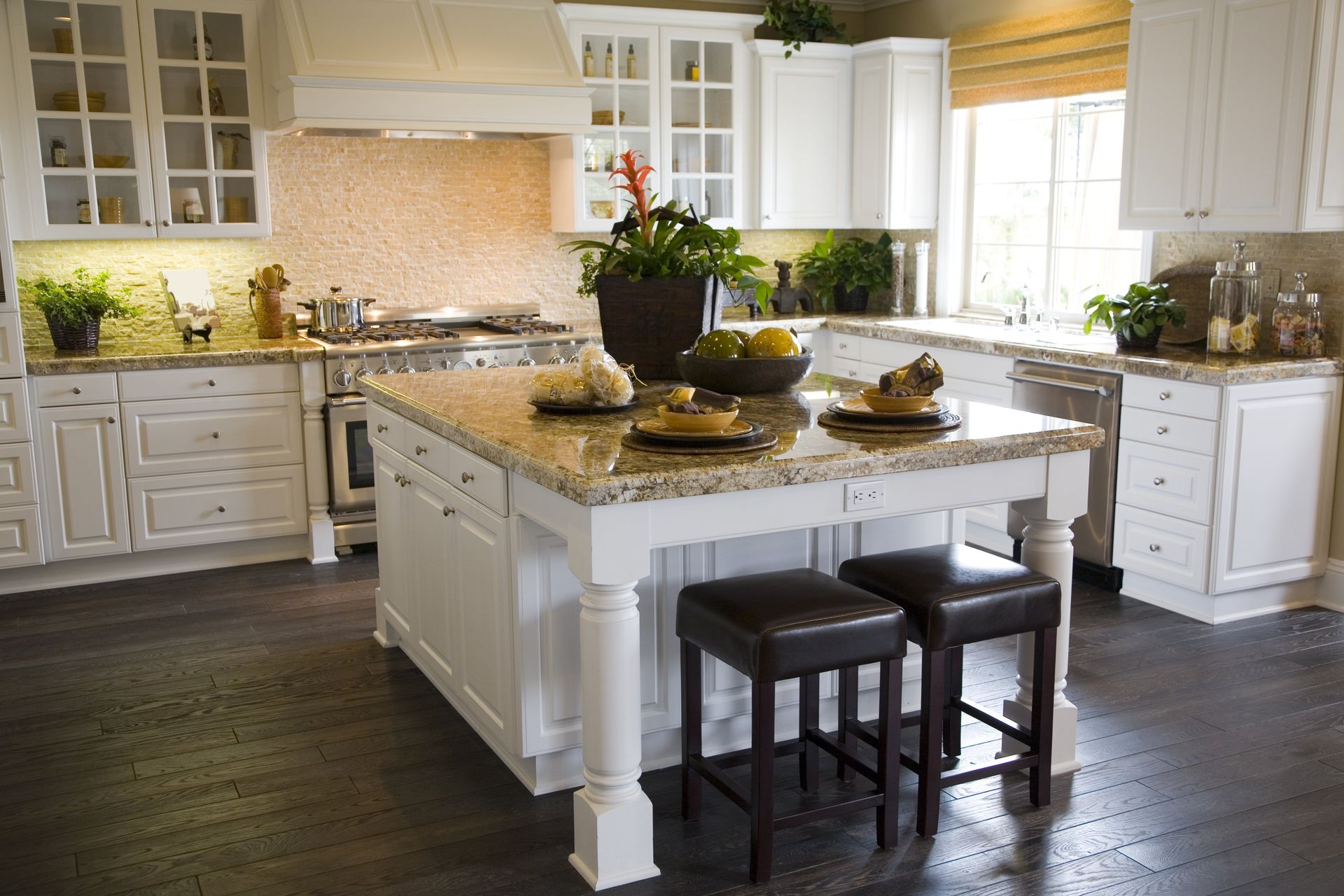A kitchen with white cabinets and granite counter tops