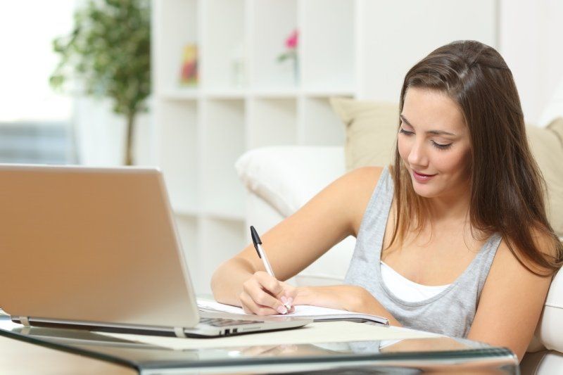 young woman writing on a piece of paper