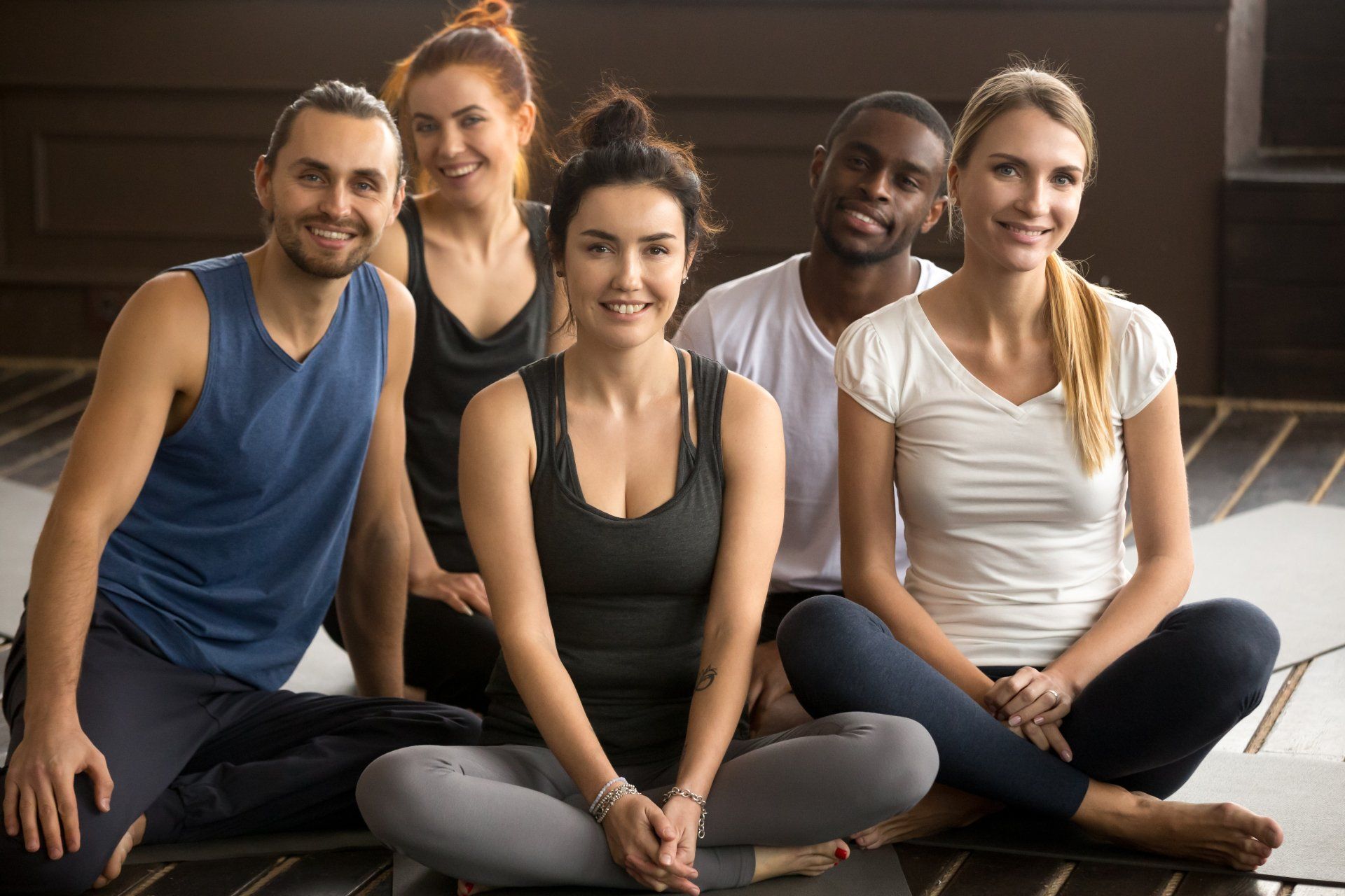 group of people sitting cross legged