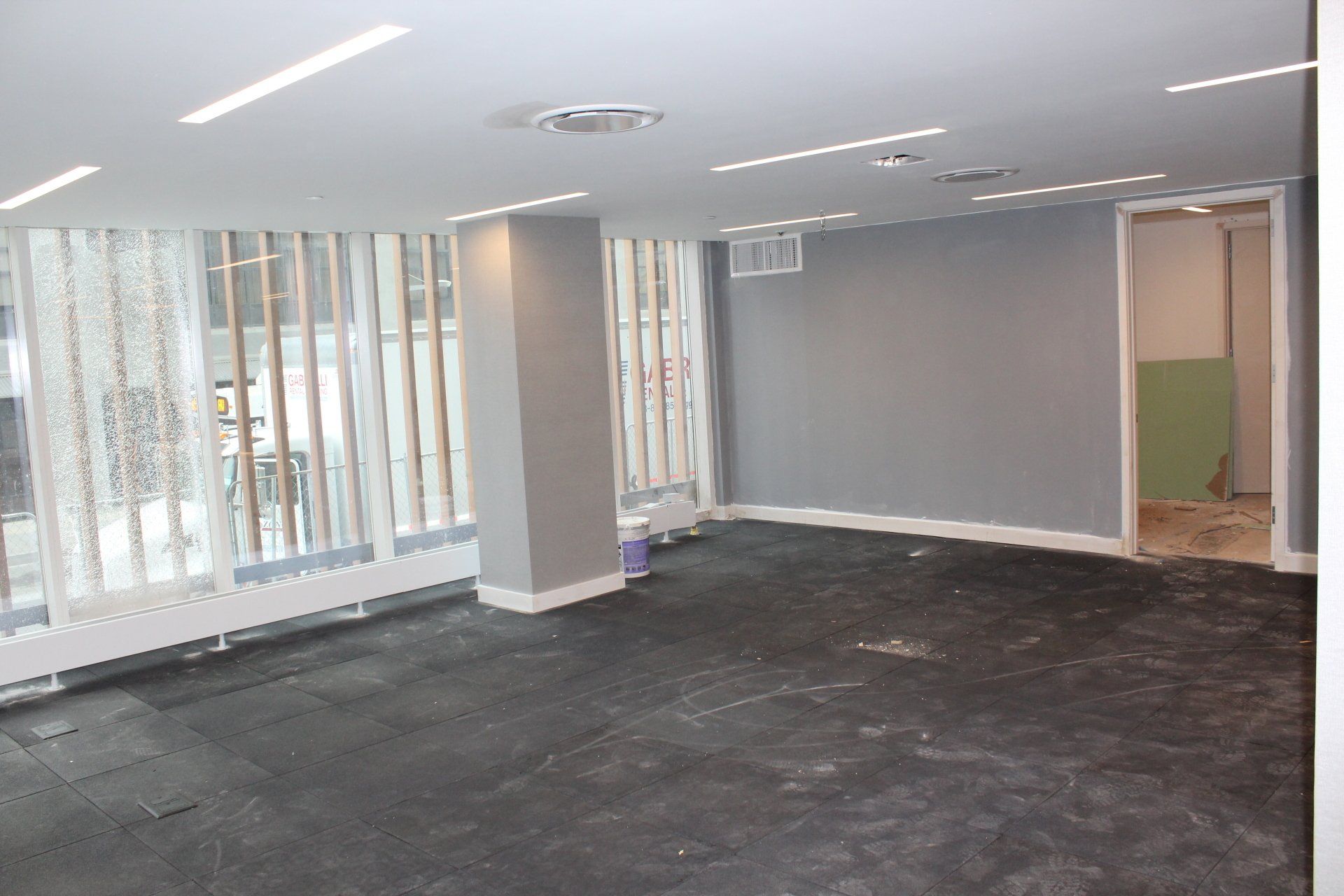 Quay Tower interior under construction with new flooring and bright natural light from large windows.