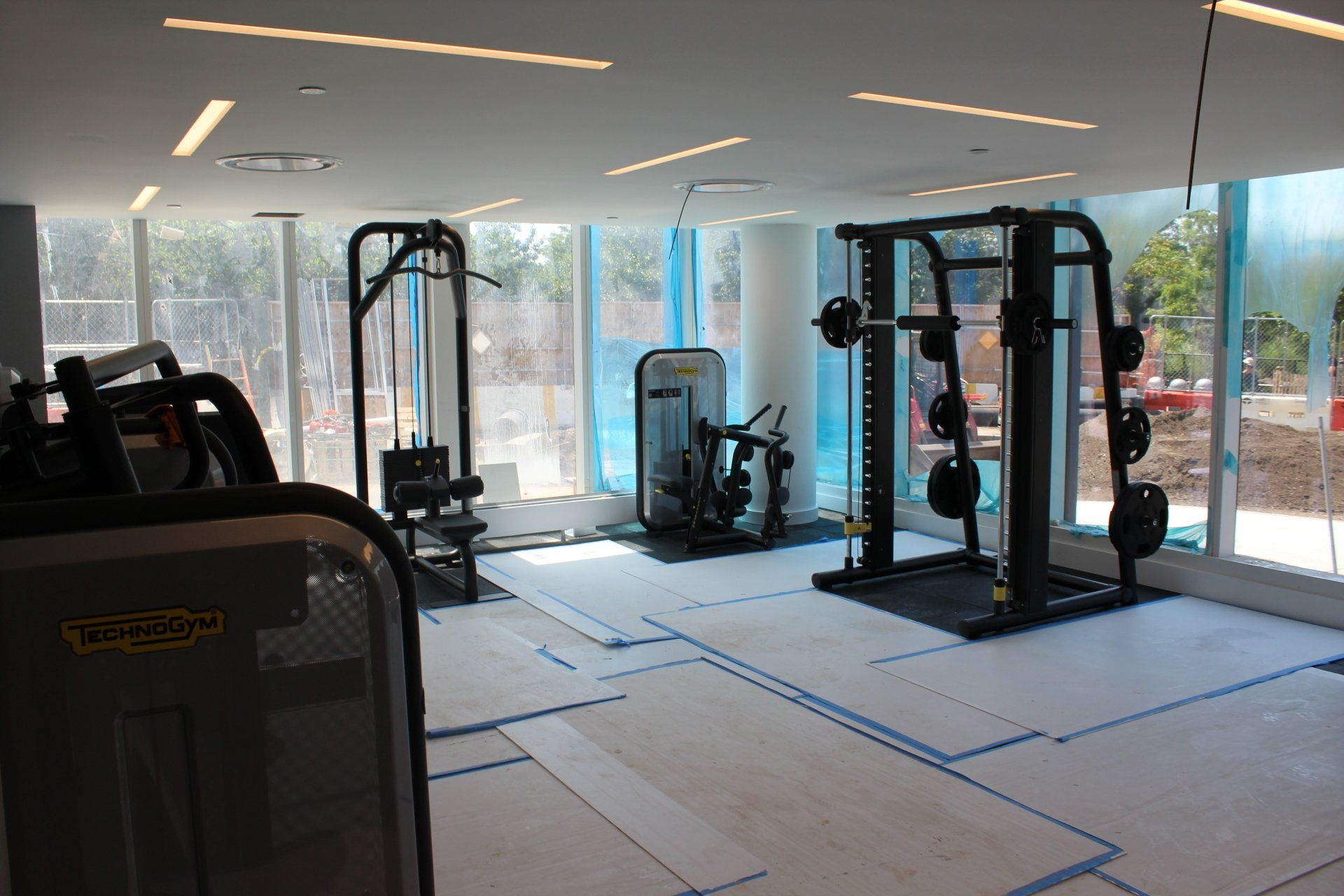 Quay Tower fitness room with strength training equipment placed on temporary flooring.