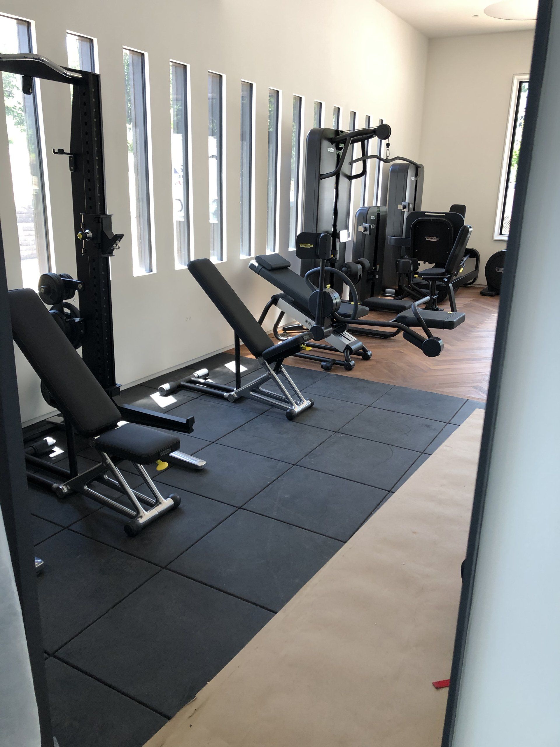 Fitness equipment installation with padded flooring in Bernardsville residential gym