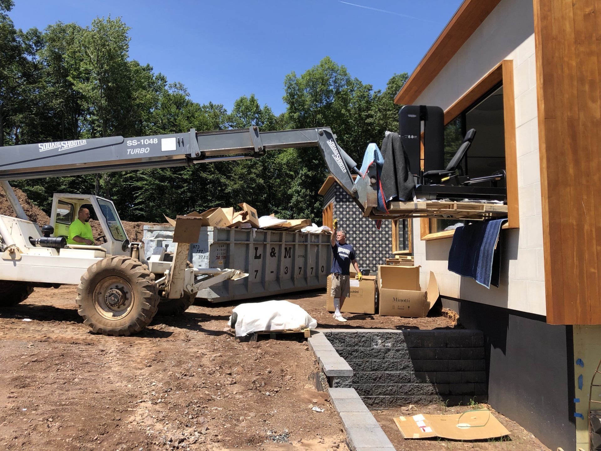 Construction equipment and crew working on modern residential build in Bernardsville.